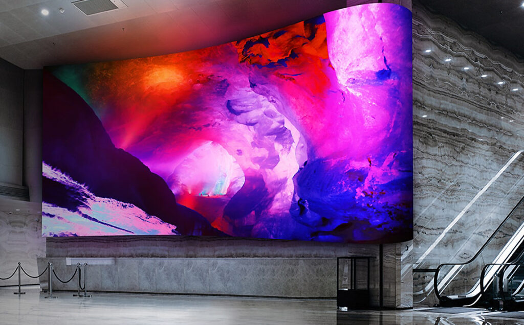 Large curved LED video wall glowing in a commercial lobby